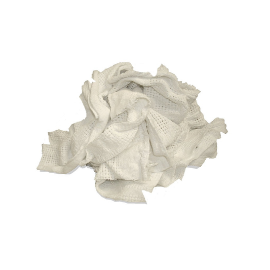 Pile of off-white thermal blanket rags showing their open-weave texture on a white background