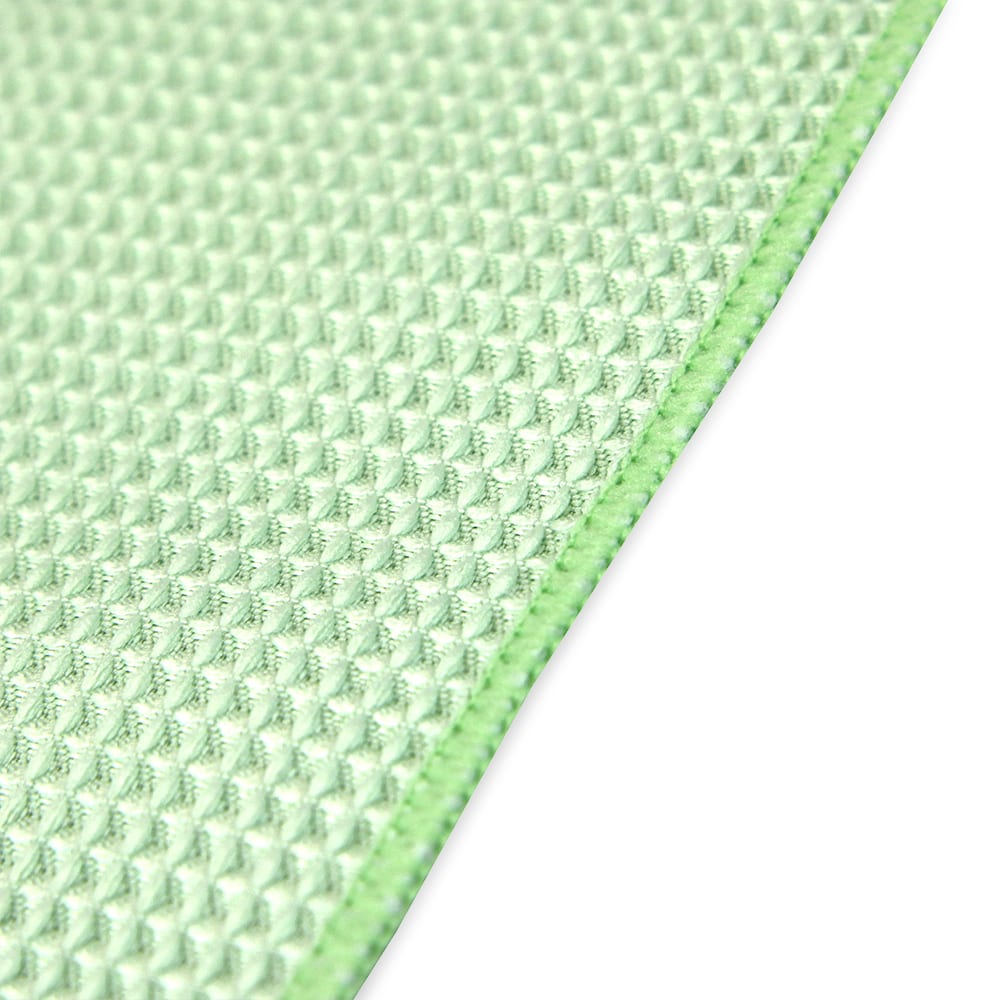 a close-up of a green waffle weave towel